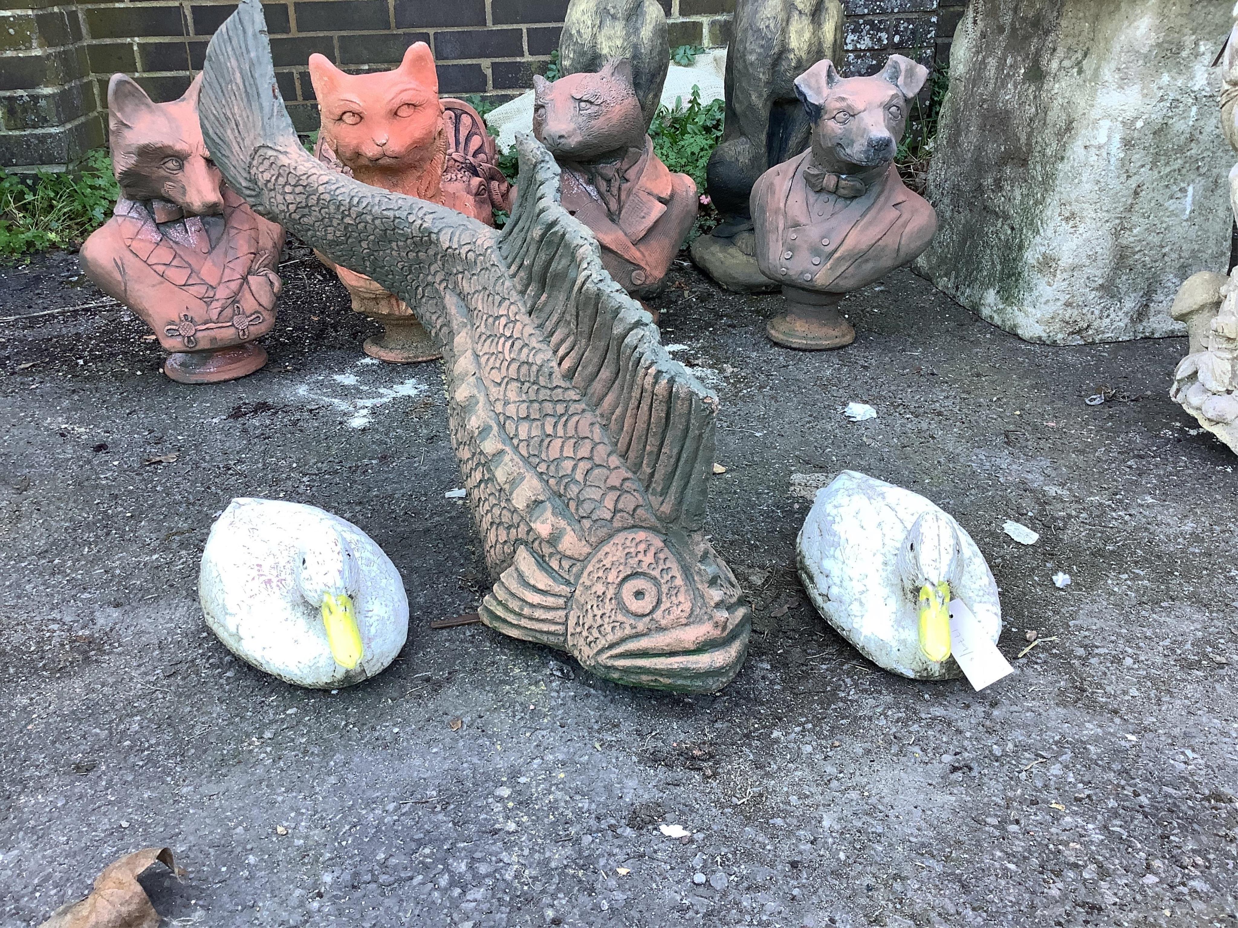 A terracotta koi fish and a pair of terracotta ducks, largest length 70cm. Condition - fair to good